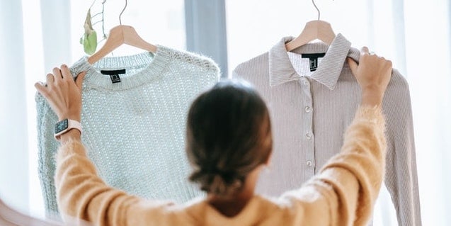 person-holding-two-shirts
