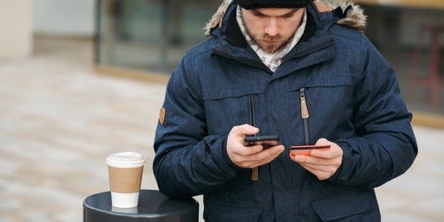person-paying-on-mobile-phone