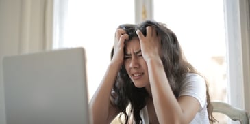 woman-stressed-and-looking-at-computer