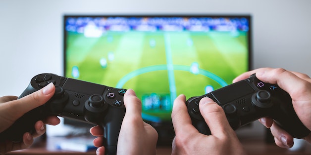 two-people-playing-with-gaming-consoles