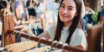 women-smiling-near-clothes-rack