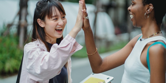 two-women-high-fiving