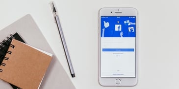 facebook-app-on-mobile-next-to-notebook-and-pen